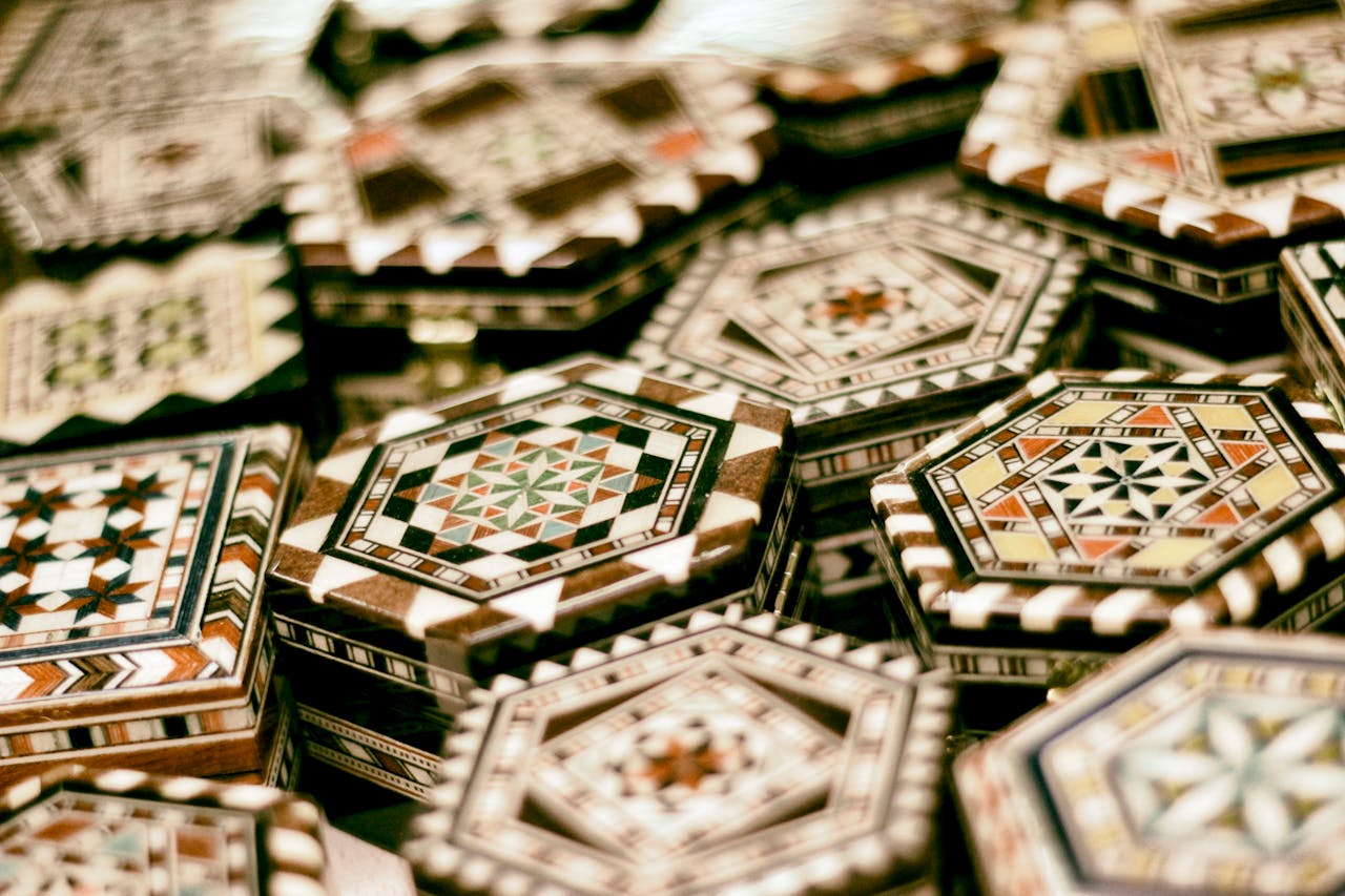 Intricately designed geometric mosaic tiles with traditional patterns in earthy tones.